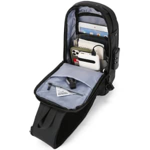 A black anti-theft sling chest bag with multiple compartments, holding a tablet, phone, notebook, and a pen.