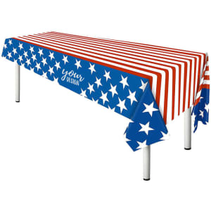 A rectangular tablecloth featuring red and white stripes, blue fabric with white stars, and a printed logo.