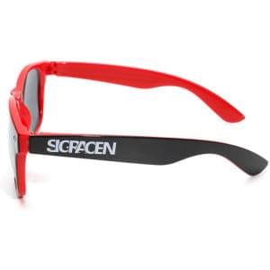 Red sunglasses with black arms, featuring a logo on the side. Suitable for leisure and outdoor activities.