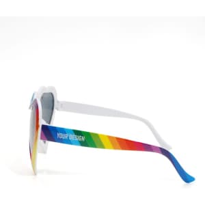 Rainbow heart-shaped sunglasses with multicoloured arms and a white frame, featuring a design area on the side.