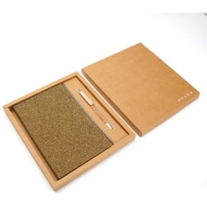 A brown biodegradable notebook with a textured cover, accompanied by a wooden pen, presented in a matching gift box.