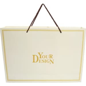 A cream gift box with a gold border and a brown handle, featuring a logo or branding on the front.