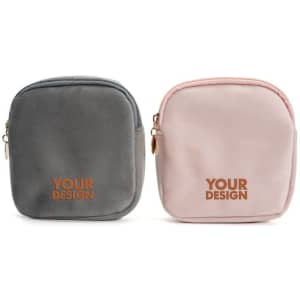 A set of two velvet travel cosmetic bags in grey and pink, featuring a logo on the front of each.