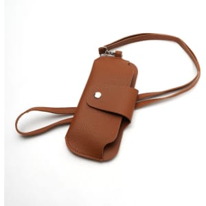 A brown portable glasses pouch with a strap, featuring a snap closure and a textured finish.