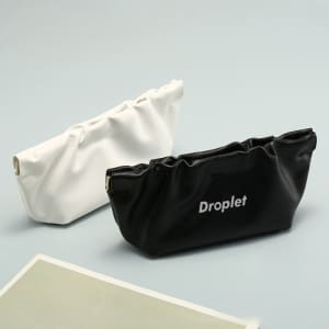 Two PU leather squeeze top sunglasses pouches in white and black, featuring a logo on the black pouch.