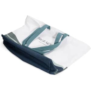 A canvas tote bag in white with blue and green accents, featuring double handles and a logo.