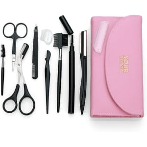 A pink eyebrow trimmer kit featuring black scissors, tweezers, brushes, and various grooming tools, enclosed in a case.