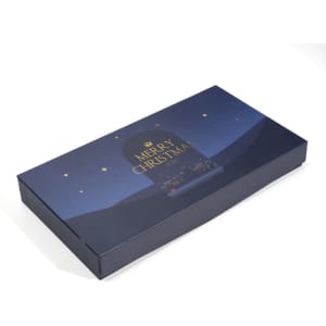 A decorative dark blue gift box featuring a "Merry Christmas" design with stars and a night scene.