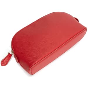 A red shell-shaped cosmetic bag with a textured surface, featuring a zipper and a small decorative tag.