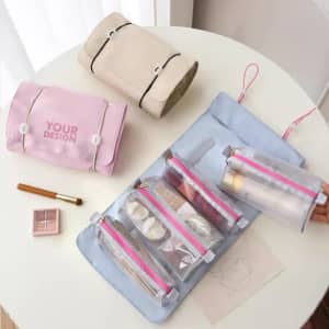 Folding travel cosmetic bags in pink and beige, with a blue bag featuring transparent pouches. Includes makeup items and a brush.