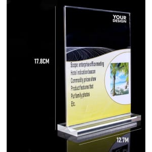 A clear acrylic table top sign holder measuring 17.8 cm high and 12.7 cm wide, featuring a base.