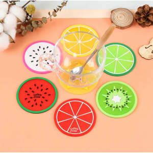 A set of vibrant, fruit-themed silicone coasters in red, pink, green, yellow, and orange surrounding a clear glass.