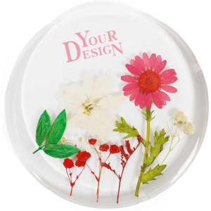 A round resin coaster featuring dried flowers in pink, white, and green, with a logo present.
