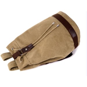 A khaki canvas drawstring backpack with brown leather accents and drawstrings. It has a logo on the side.