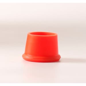 A bright red reusable silicone wine stopper with a round base and tapered top. It has a smooth finish.