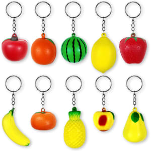 A collection of ten colourful fruit-shaped stress ball keychains, including apples, oranges, and bananas, each with a keyring.