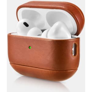 A vintage leather protective box in brown, holding white wireless headphones, with a small indicator light.