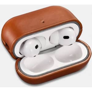 A brown leather headphone protective box opened, featuring white headphones inside. It has a logo on the exterior.