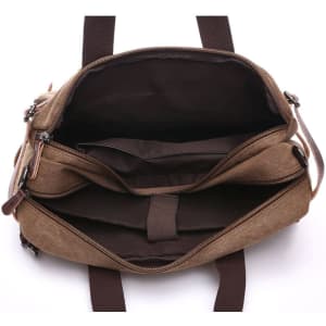 A vintage hand-held single shoulder bag in brown, featuring multiple compartments and a dark interior.