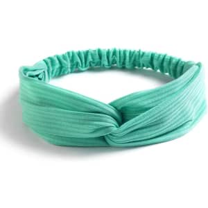 A knotted headband in a light mint green colour, featuring a stretchy band for a comfortable fit.