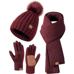 A burgundy winter bobble hat, scarf, and gloves set featuring a faux fur pom-pom and a logo.
