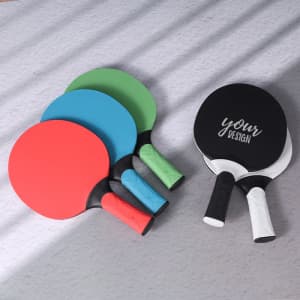 A set of custom table tennis rackets in red, blue, green, and black, featuring various handle designs.