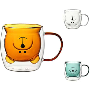 A double wall glass coffee cup in orange, with a playful design, alongside clear and blue versions; features a logo.