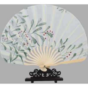 A decorative folding hand fan featuring a floral design in green and red, displayed on a black stand.