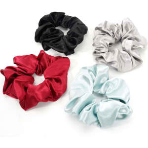 Four satin scrunchies in black, silver, red, and light blue, arranged together with a branding logo visible.