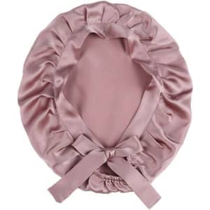 A pink silk bonnet with a ruffled design and tie at the back, featuring a smooth inner lining.