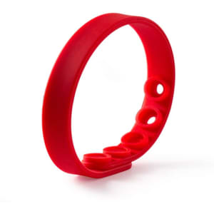 A red adjustable silicone wristband featuring multiple sizing holes and a smooth finish. It has a logo.