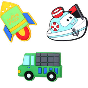 Three colourful fridge magnets featuring a rocket, a boat, and a green truck, each with unique shapes and designs.