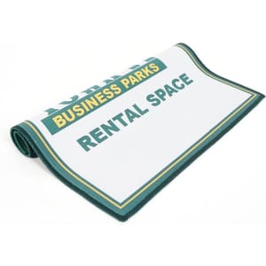 A green and white eyeglass cleaning cloth with a border and the branding logo, designed for lens cleaning.