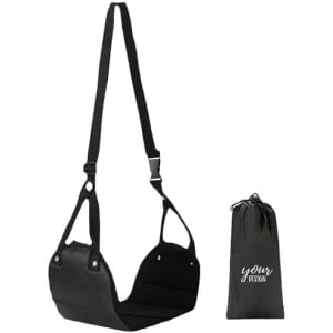 A black portable footrest with adjustable straps and a matching carry bag for storage.