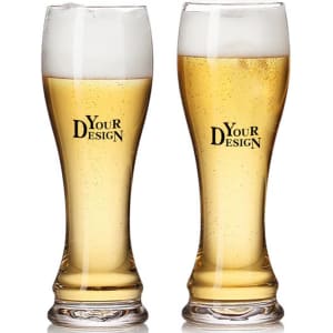Two tall, curved wheat beer glasses filled with golden beer and topped with frothy white heads, featuring a logo.
