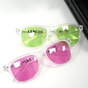 Polarised transparent sunglasses with green and pink lenses, featuring a clear frame and a logo on the side.