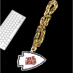 A custom gold chain necklace featuring an oversized pendant in a unique shape, with a blank design space.