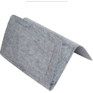A grey felt bedside pocket with one large compartment and a folded design for easy placement.