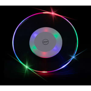 A translucent round LED coaster with multicoloured lights around the edge and a central white button.