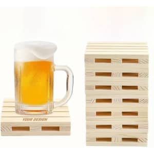 A drink bottle rests on a light wooden pallet coaster, with several more coasters stacked beside it.