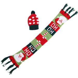 A drink bottle is dressed in a red and green knitted hat and scarf featuring Santa and candy cane designs.