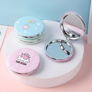 A set of custom folding pocket mirrors featuring pastel colours and playful designs, displayed on a white pedestal.