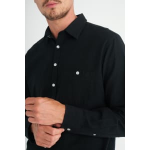 A black long sleeve button-up shirt with a chest pocket and buttons visible on the cuffs.
