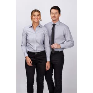 A ladies' long sleeve button-up shirt in light blue, featuring a tailored fit, alongside a matching men's shirt.
