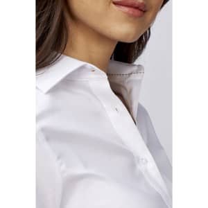 A close-up of a stylish white ladies' long sleeve button-up shirt with a classic collar and a branding logo.