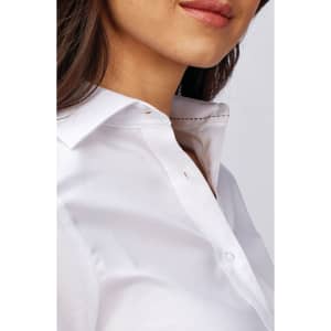A close-up of a women's button-up shirt in white, featuring a classic collar and subtle detailing.