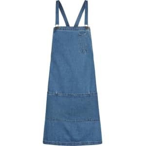 A denim bib apron in blue with adjustable straps and a front pocket. It features a simple, classic design.