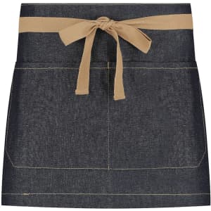A short waist apron in navy denim with a tan tie, featuring a simple design and pockets. It has a logo.