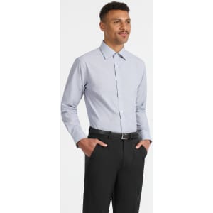 A light blue button-up long sleeve shirt worn by a man, paired with black trousers. The shirt features a logo.