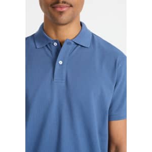 A blue men's polo shirt featuring a classic collar and button placket, showcasing a subtle branding element.
